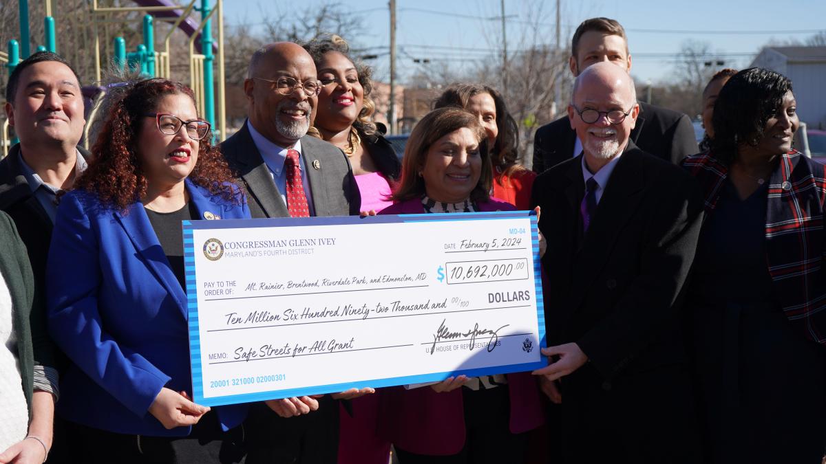 Congressman Ivey and other Maryland dignitaries hold an oversized check representing funds received from the Safe Streets for All grant.