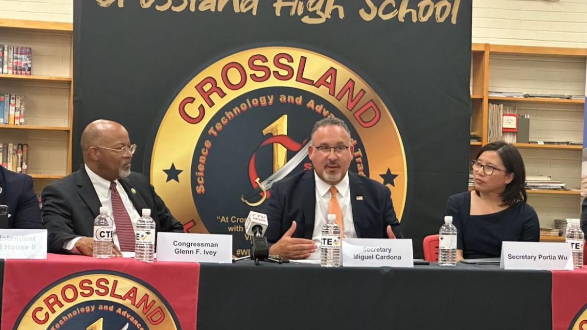 Maryland Rep. Glenn Ivey (left) is joined by U.S. Secretary of Education Miguel Cardona (center) and Maryland Secretary of Labor Portia Wu at Crossland High School to talk about trade programs and what they can do for students. (Anthony Tilghman/The Washington Informer)