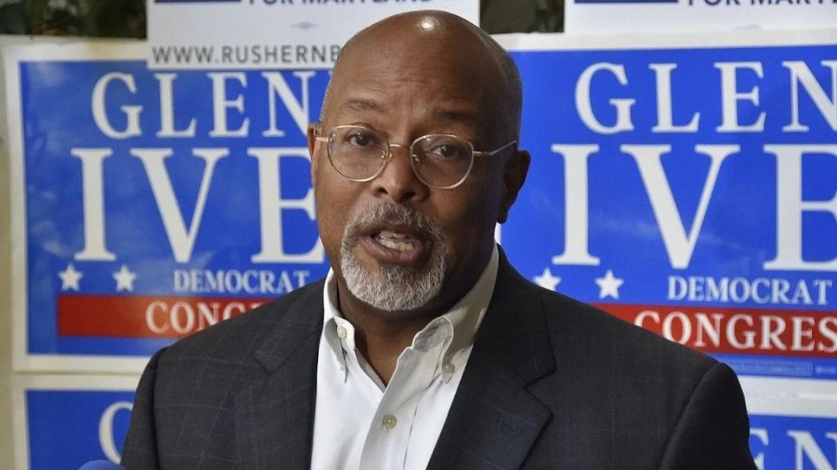 Congressman Glenn Ivey speaks in front of signs promoting his campaign.