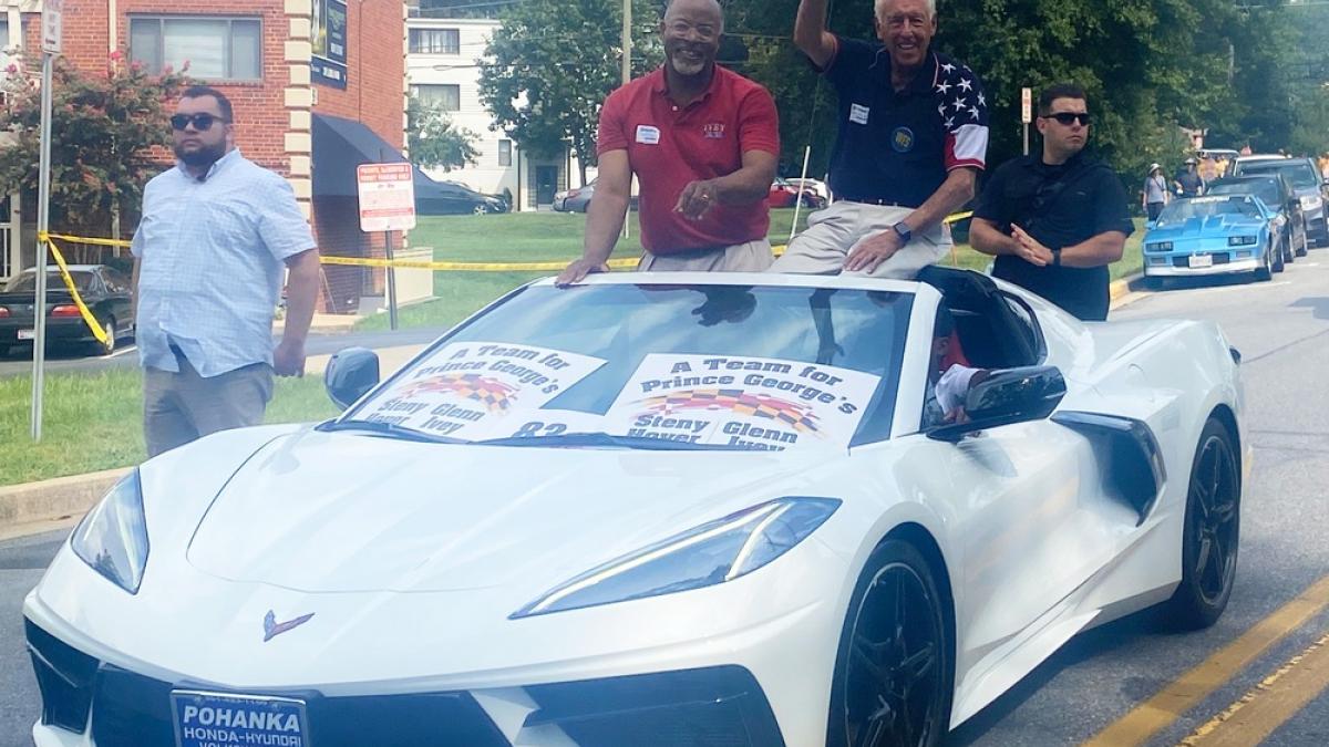 Congressmen Glenn Ivey and Steny Hoyer wave from a Corvette convertible during the 2022 Labor Day Parade.