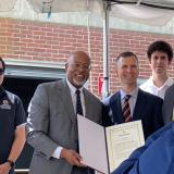 Rep. Glenn Ivey (D-Md.) presents a certificate to University of Maryland students during his visit to the Maryland Fire and Rescue Institute.
