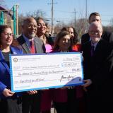 Congressman Ivey and other Maryland dignitaries hold an oversized check representing funds received from the Safe Streets for All grant.