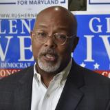 Congressman Glenn Ivey speaks in front of signs promoting his campaign.